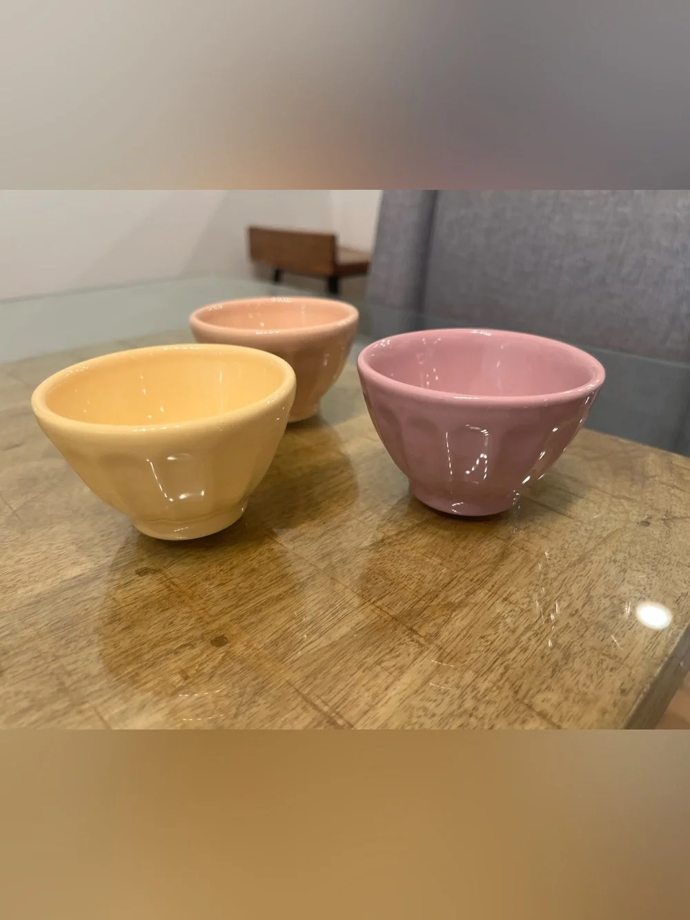 3 Anthropologie glazed ceramic bowls in peach, yellow, and mauve